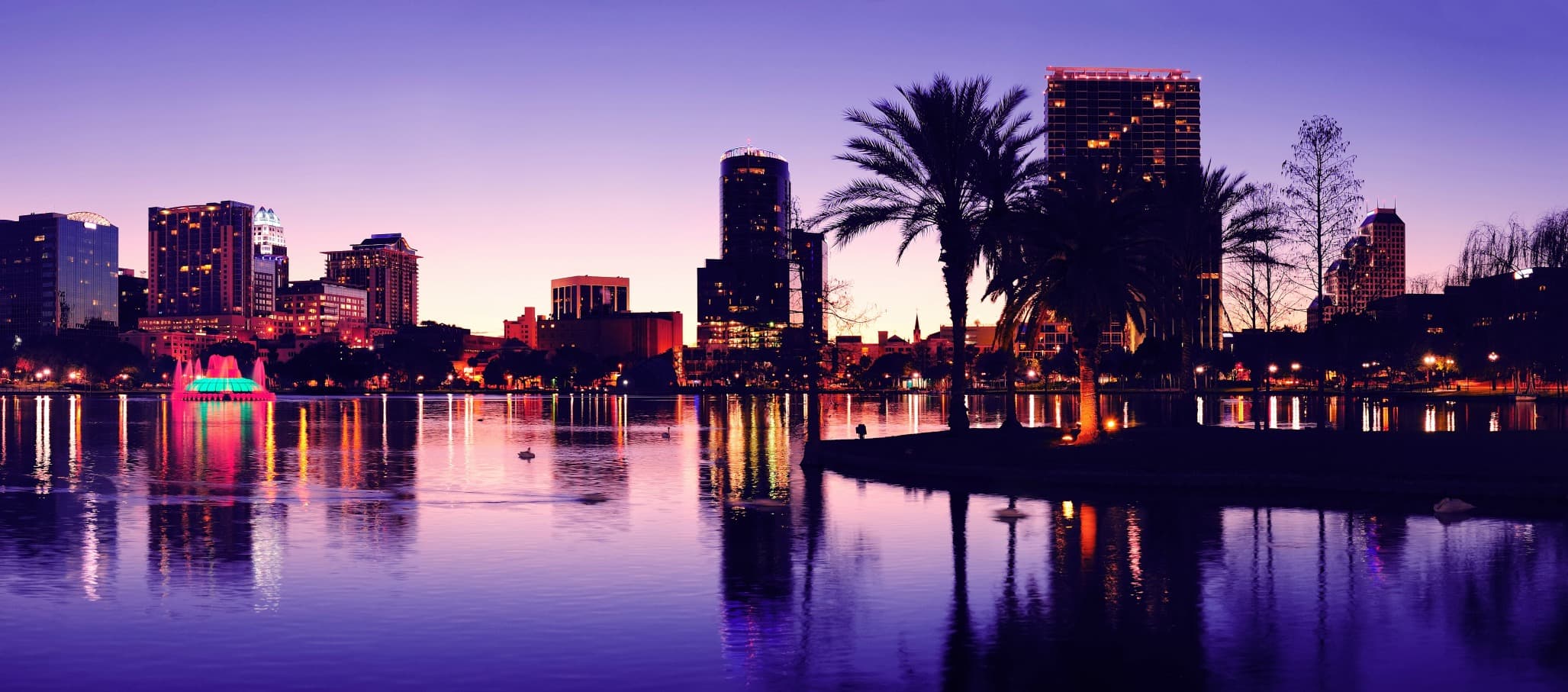 Orlando downtown skyline panorama silhouette over Lake Eola at dusk with urban skyscrapers.; Shutterstock ID 133238030